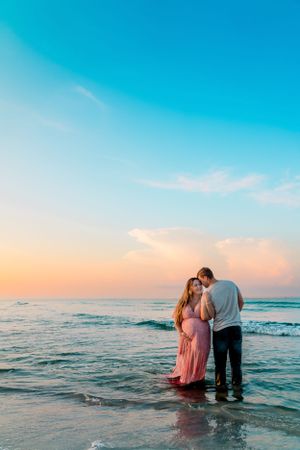 Outdoor maternity session capturing movement and connection, photographed by Sierra Lopez Productions.