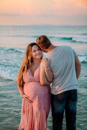 Maternity photo capturing an expecting parent in soft natural light, photographed by Sierra Lopez Productions.
