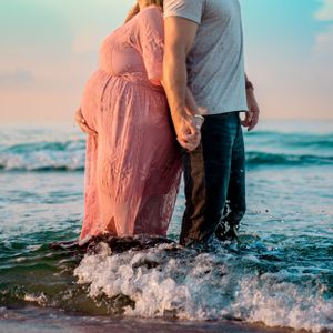 Outdoor maternity session capturing movement and connection, photographed by Sierra Lopez Productions.