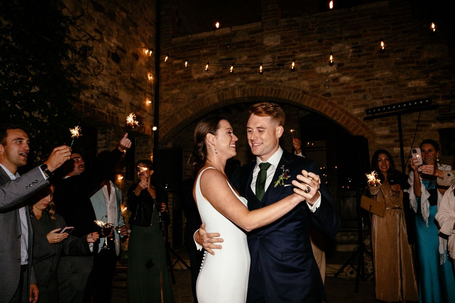 The first dance surrounded by sparklers at the Lazy Olive wedding venue in Tuscany.
