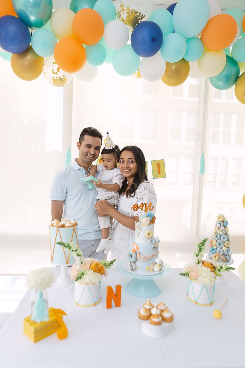 an indian couple holding their son during his musical themed birthday party in Hoboken at their apartment photo by Paula