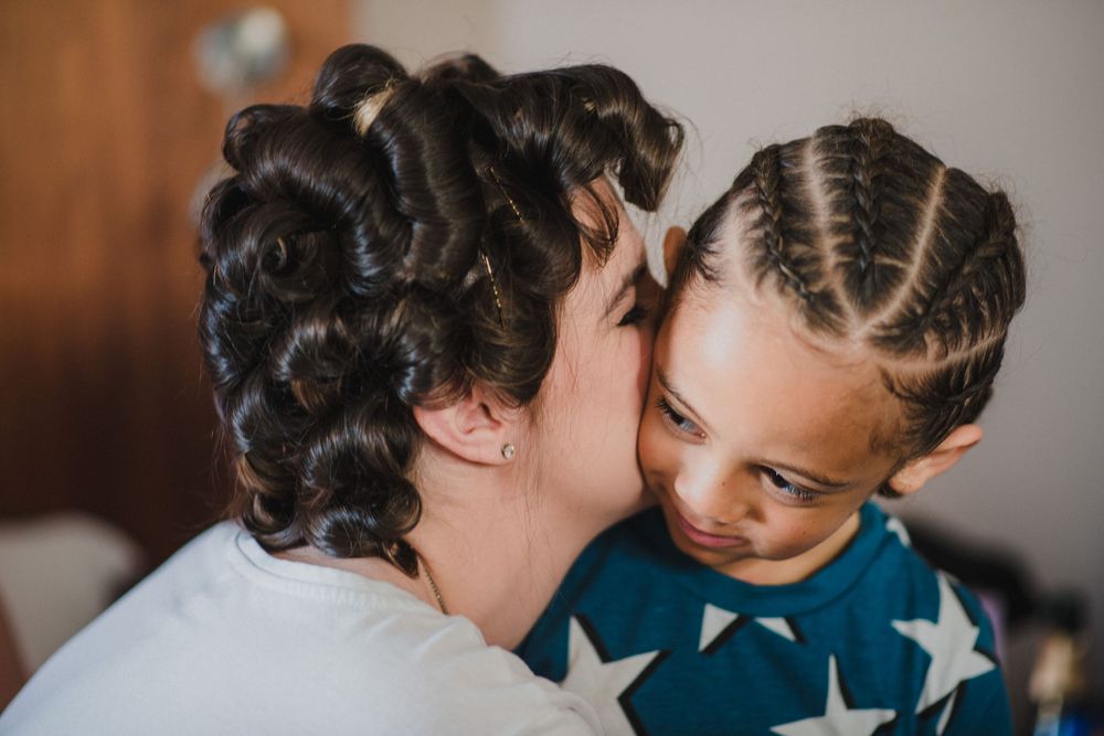 An intimate moment captured between two people with styled hair.