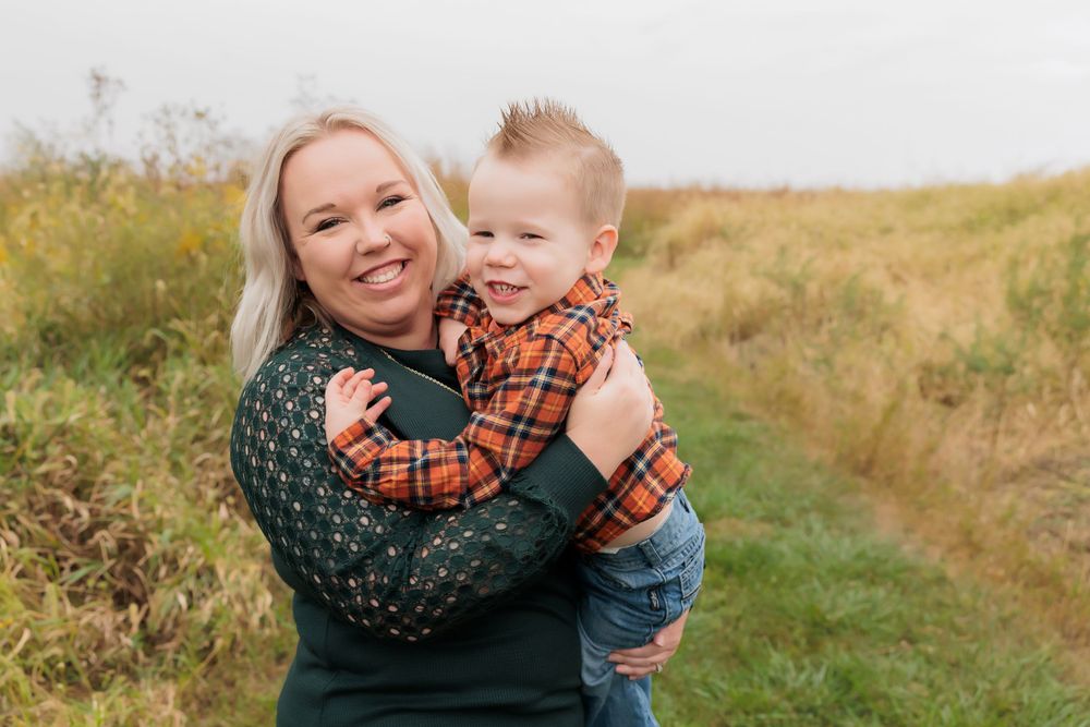A cheerful outdoor portrait shared between two people on a fall afternoon.