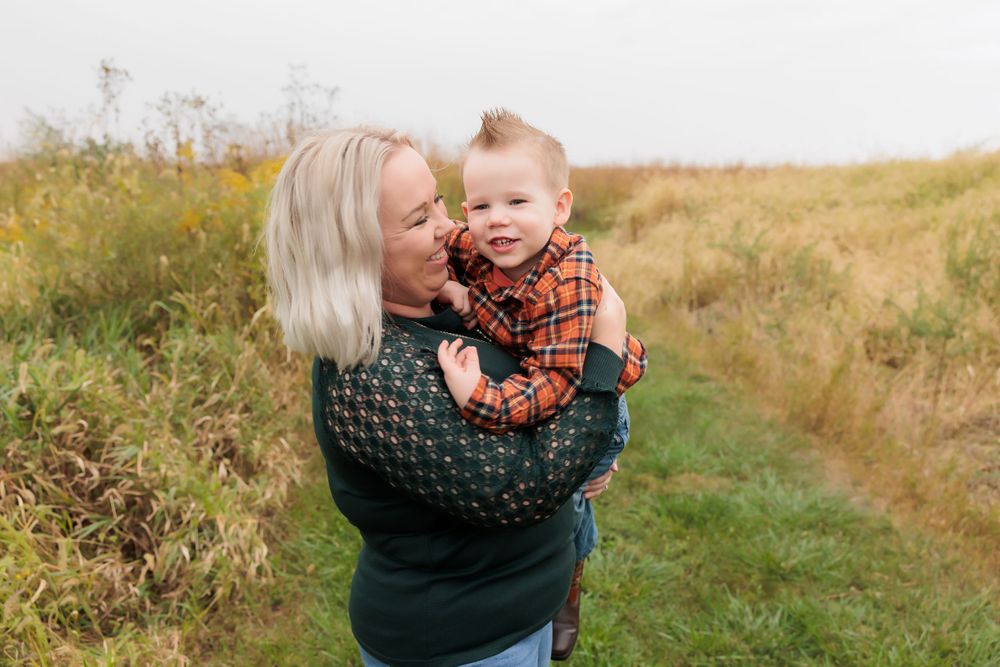 An intimate portrait showing tender affection amidst a natural autumn setting.