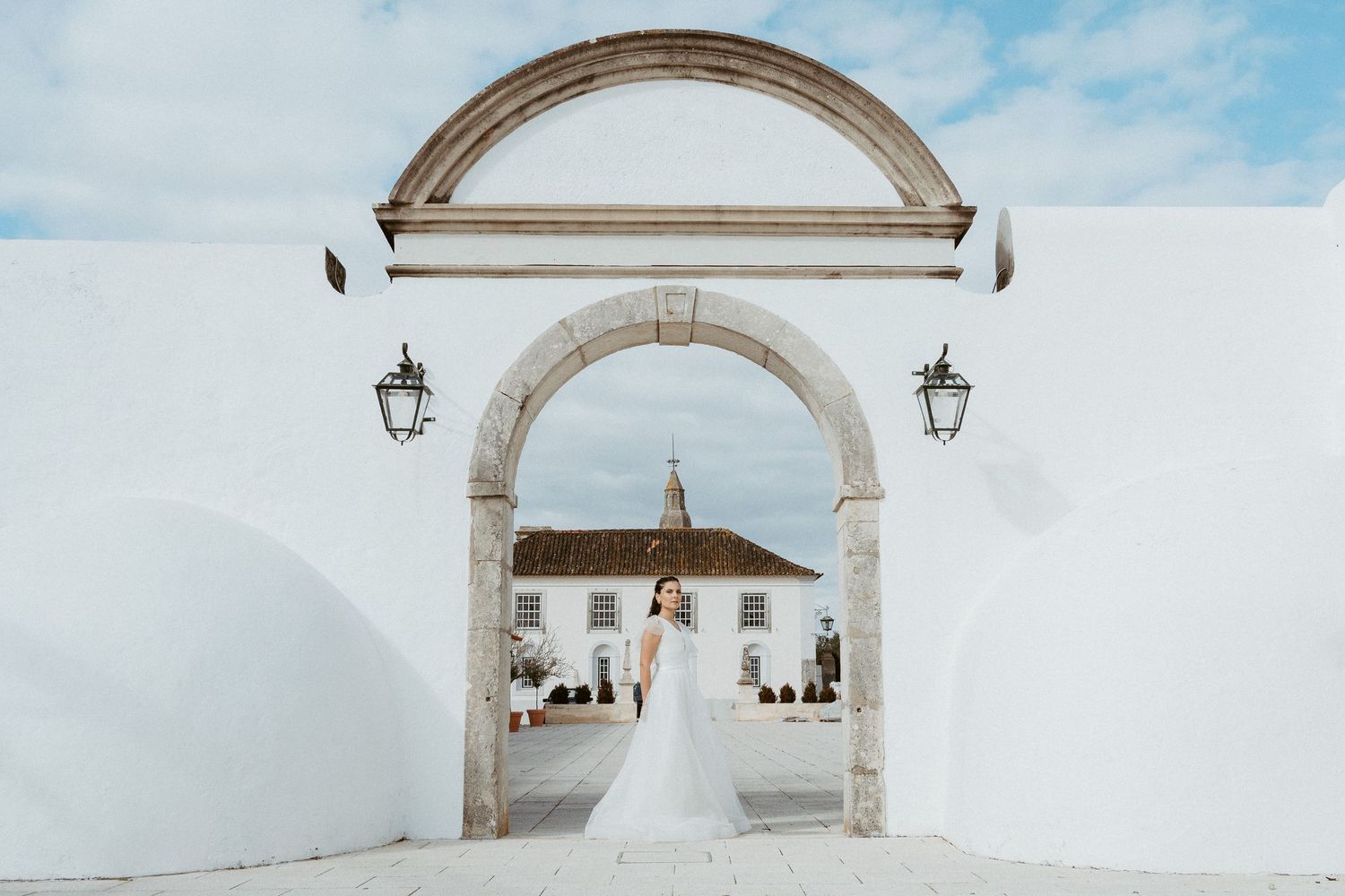 Stone archways and blue sky create a beautiful Mediterranean architectural scene.