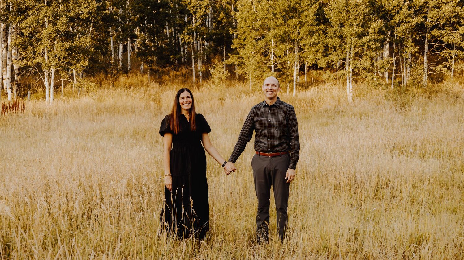 A warm and candid portrait of a couple/family, captured in natural light, with a timeless background.