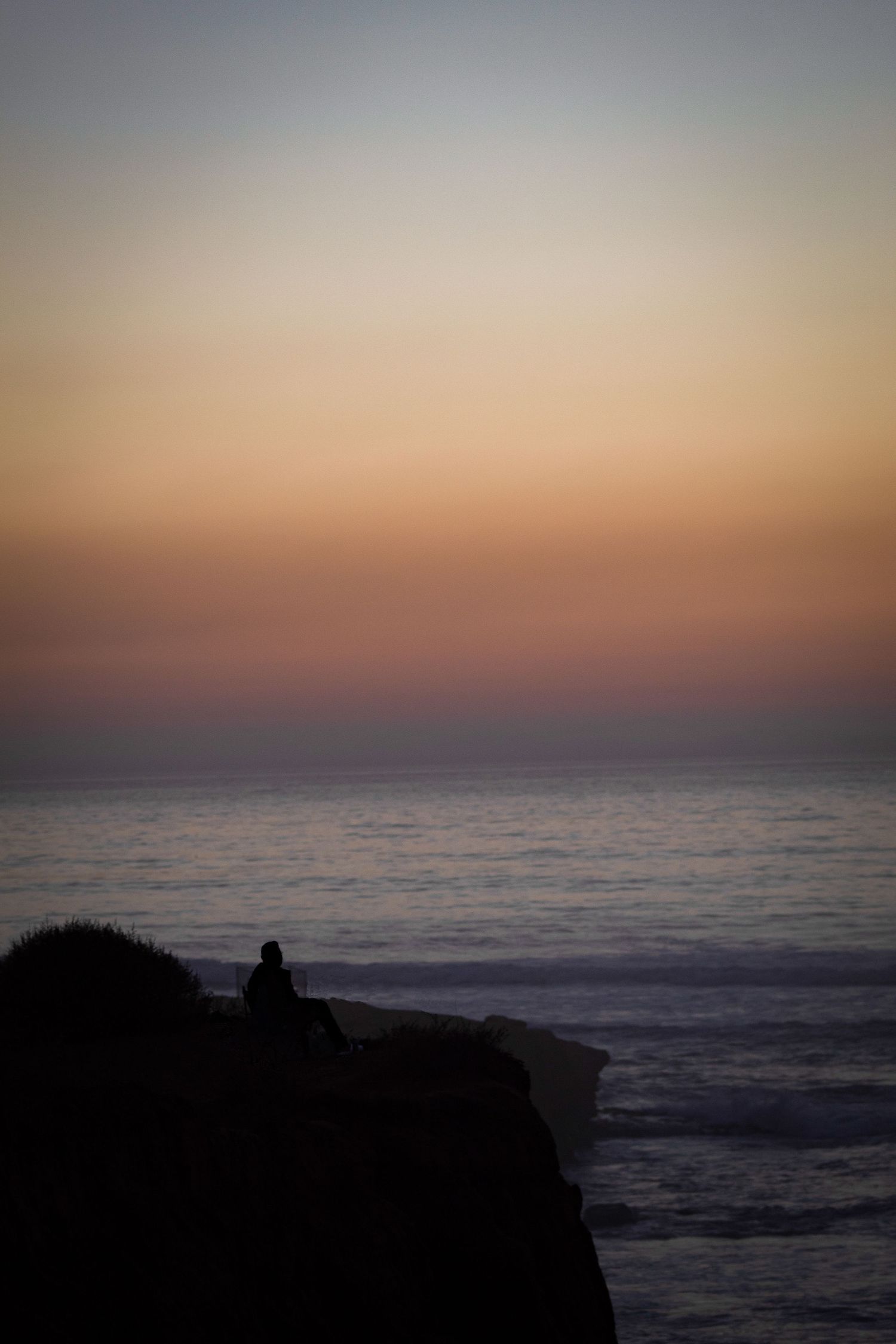 man enjoying the sunset at sunset cliffs in san diego, ca