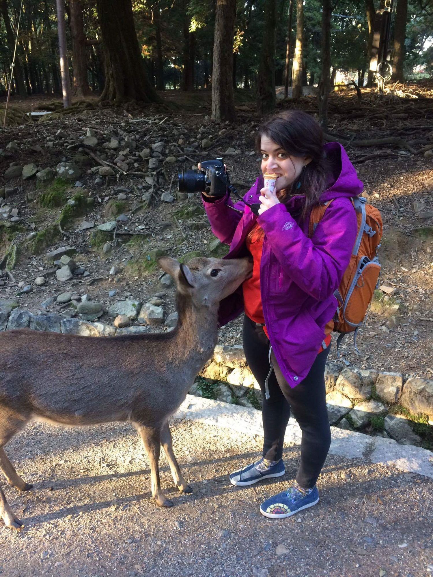 Leah Ramuglia eating ice cream with a wild deer in Nara, Japan.