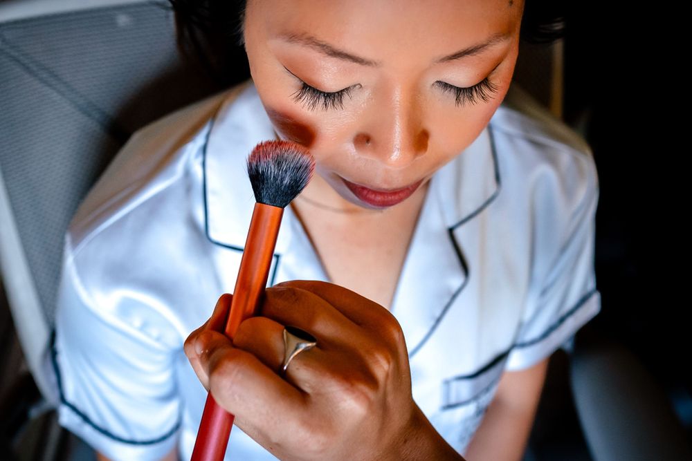 Close-up shot of makeup application with a cosmetic brush.