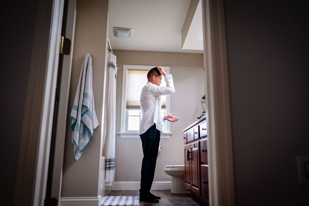 Atmospheric hallway shots showing preparation moments in natural window light.