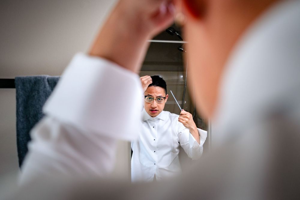 Close-up details of formal attire and accessories being adjusted.