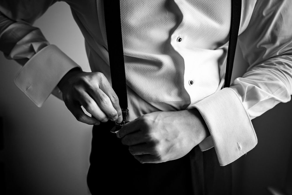 Detail shots of formal white dress shirt and accessories in black and white.