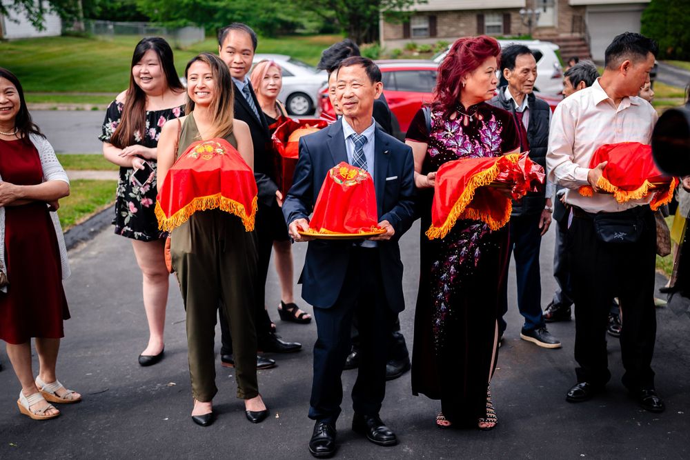 Wedding party members in formal attire gather outdoors for group photos.