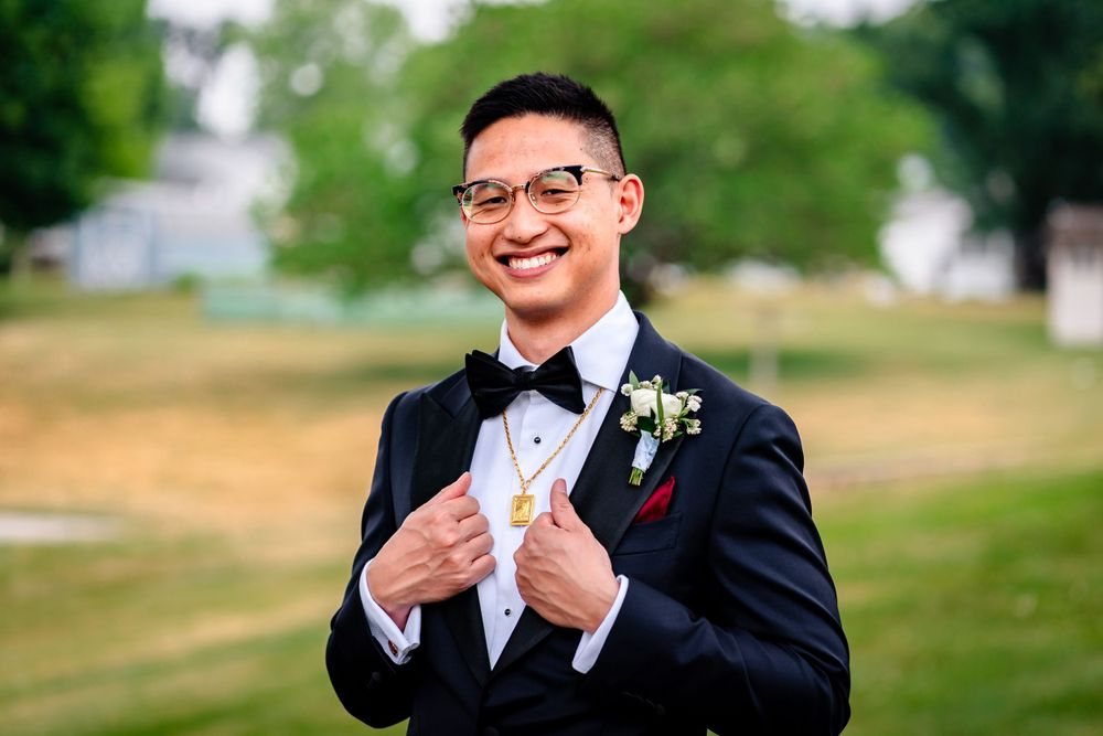 Wedding portraits captured in natural outdoor setting with green grass backdrop.