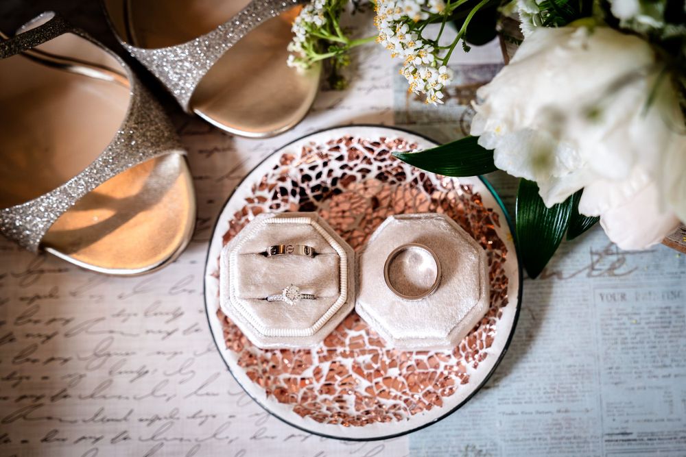 Vintage teacups and delicate lace details arranged on white surface.