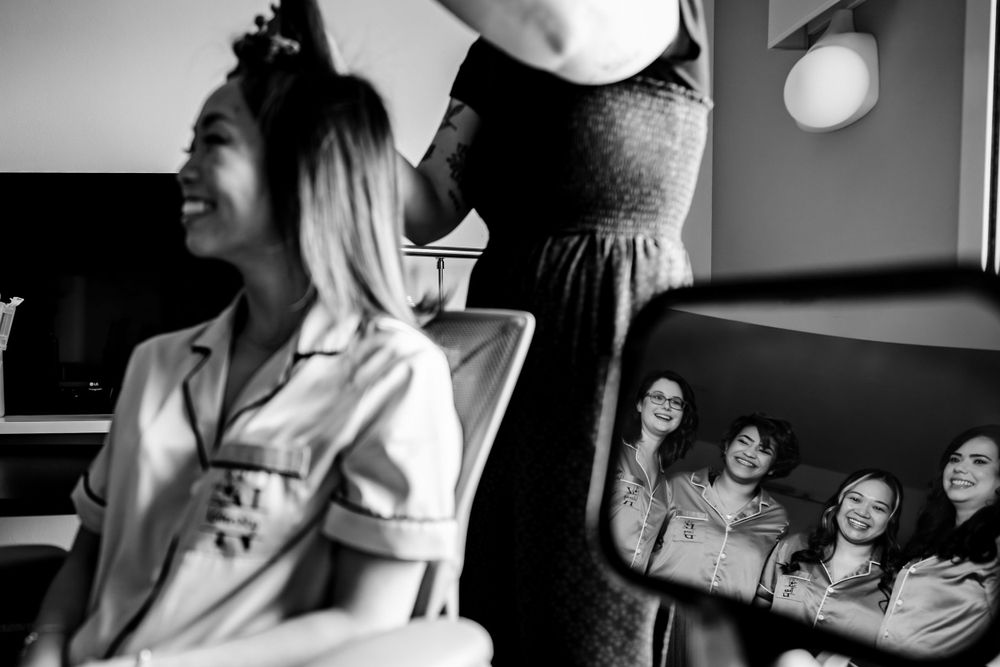 Black and white photo series showing laughter and joy during wedding day preparations.