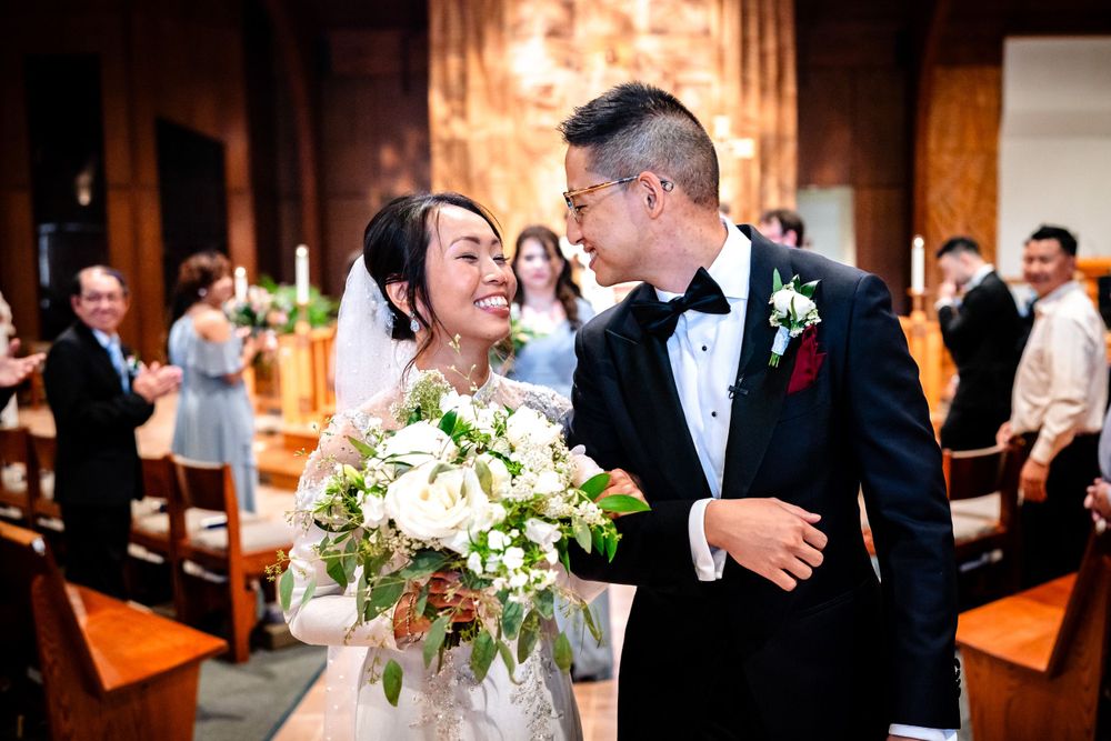 Romantic wedding ceremony moments inside an ornate church with warm lighting and brick walls.