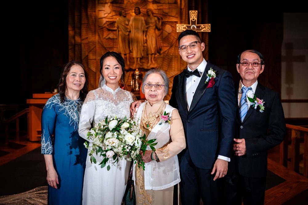 Wedding party group photos taken inside a traditional church with brick walls and warm lighting.
