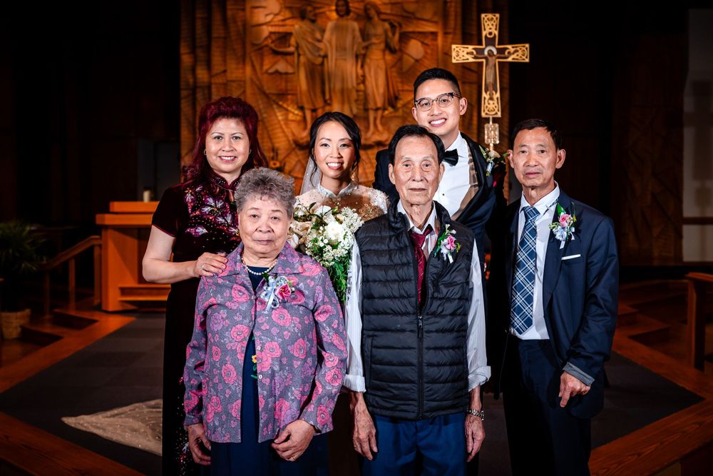 Family group portraits taken inside church sanctuary with decorative brick walls and warm lighting.