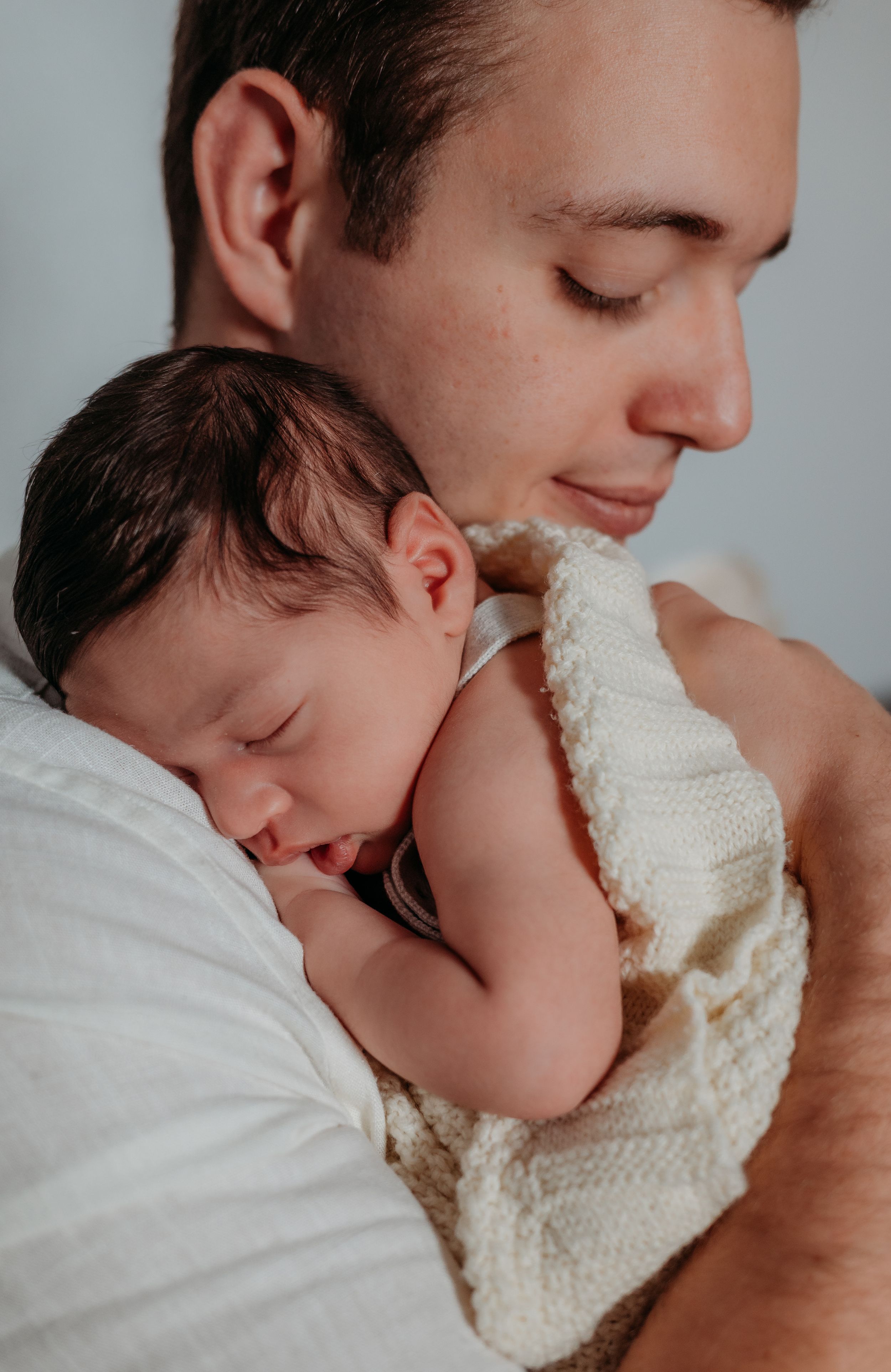 in-home newborn photo shoot with father