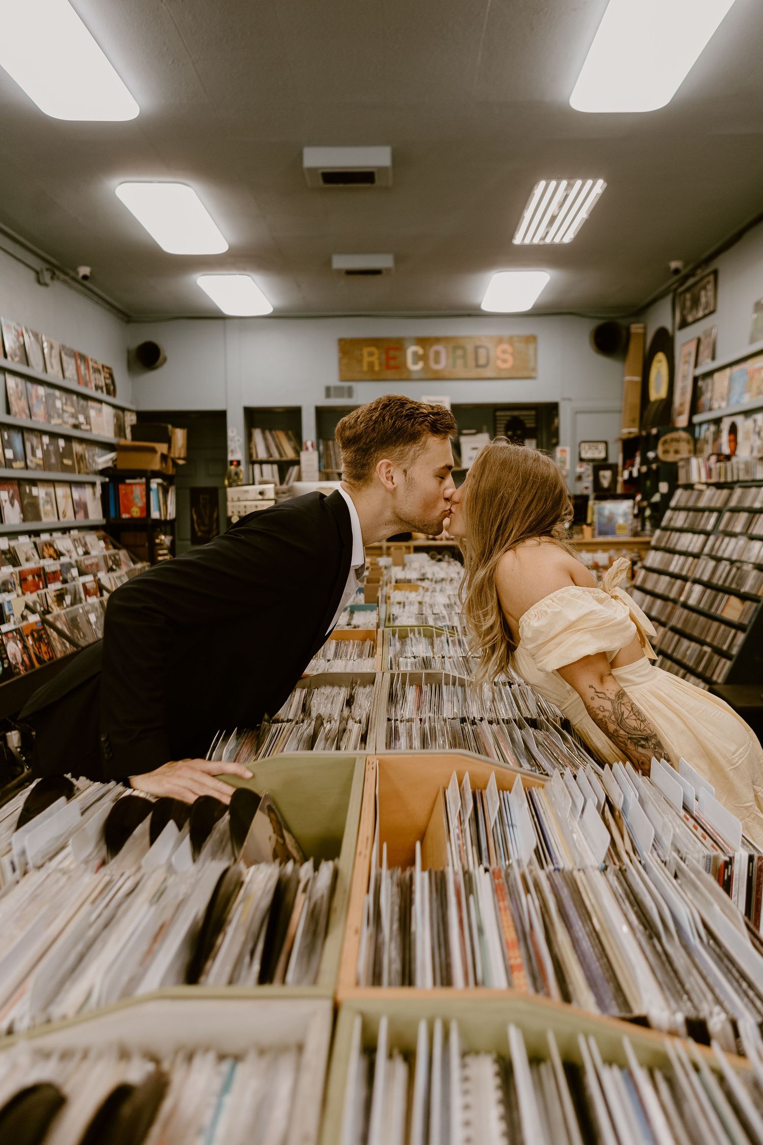 Couple kissing in a record store in downtown Fairhope, Alabama.