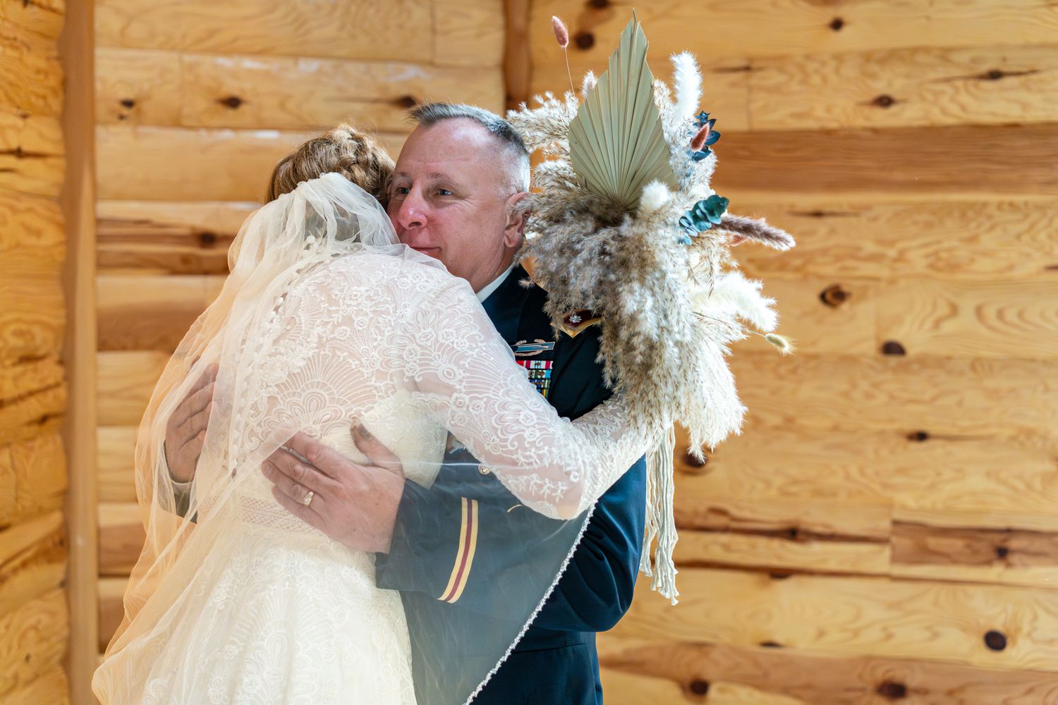 father of the bride hugs her