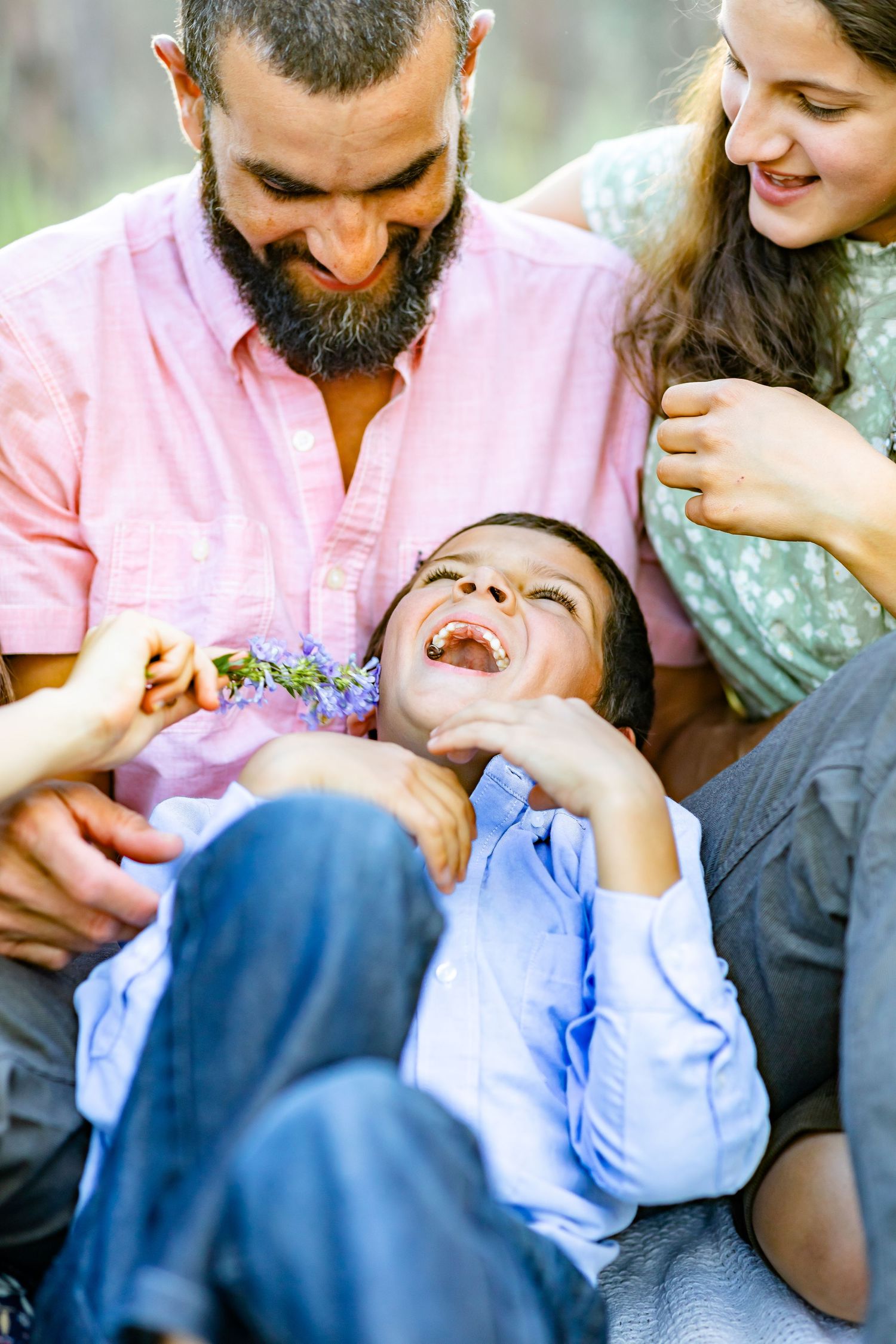 Young boy giggles as his family tickles him during their family session in Colorado Springs.
