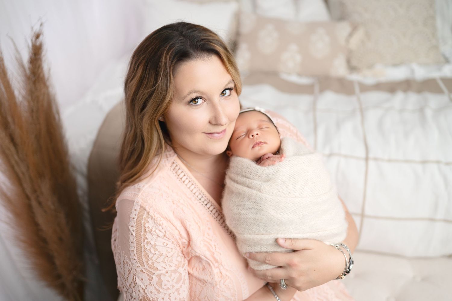 Light and airy family portraits showing intimate moments with newborn baby.