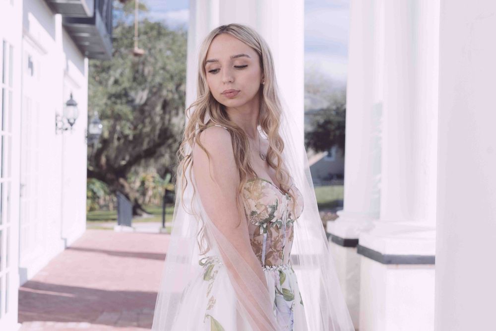 An ethereal bridal portrait featuring a floral applique gown in a soft dreamy style.