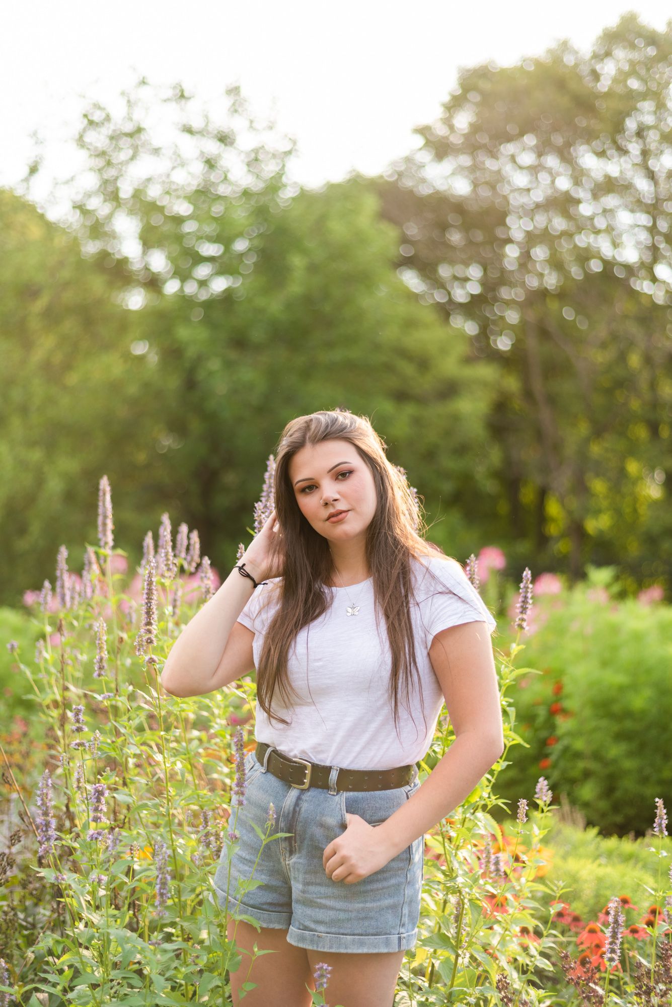 Senior standing in flower garden at Hartwood Acres in Pittsburgh Pennsylvania