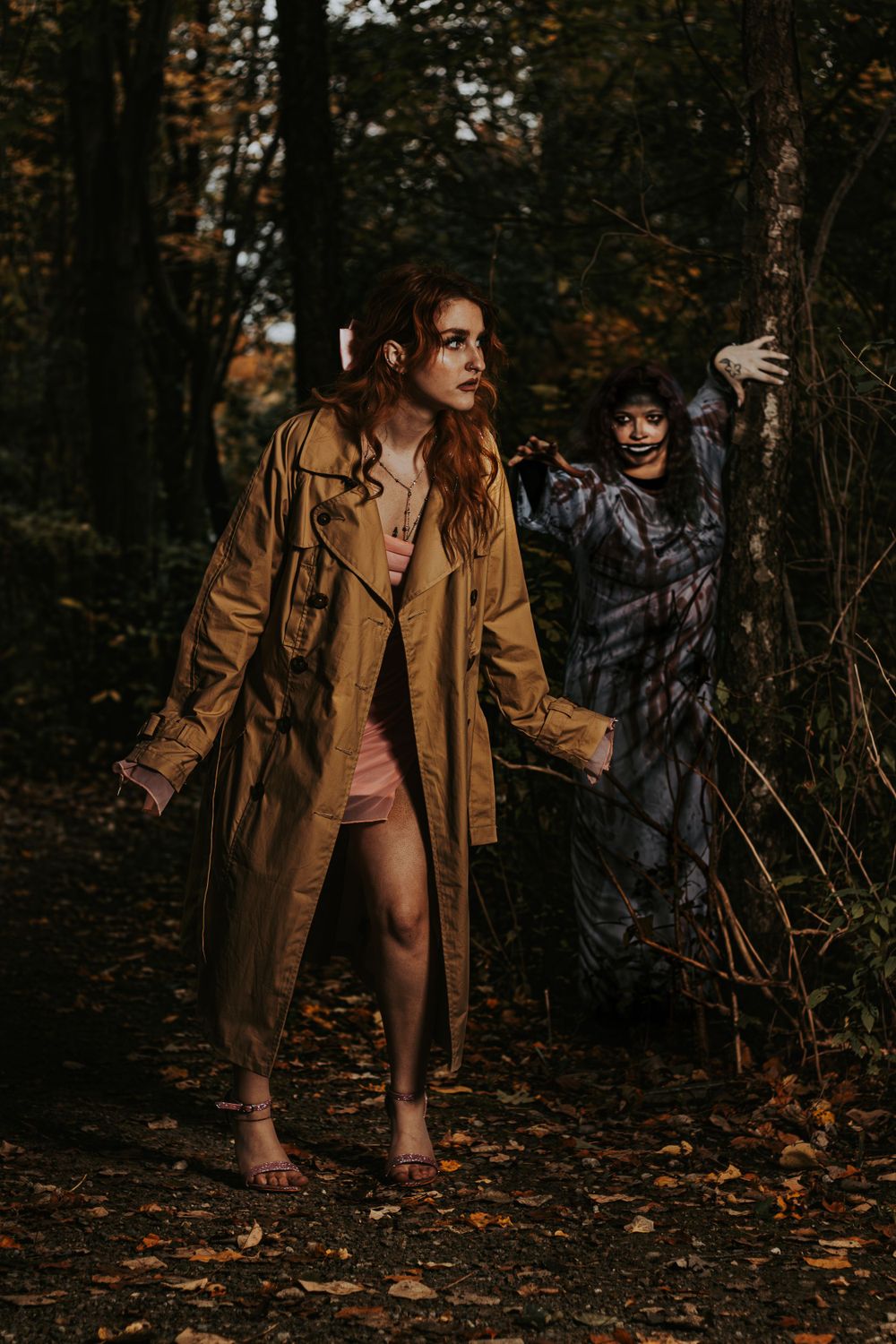 Atmospheric forest photoshoot featuring model in tan coat with mysterious storytelling elements.