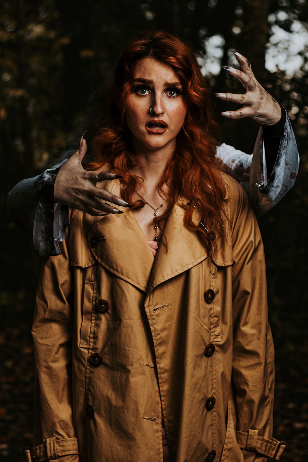 Dramatic fashion portraits in tan trench coat with expressive poses in dark forest setting.