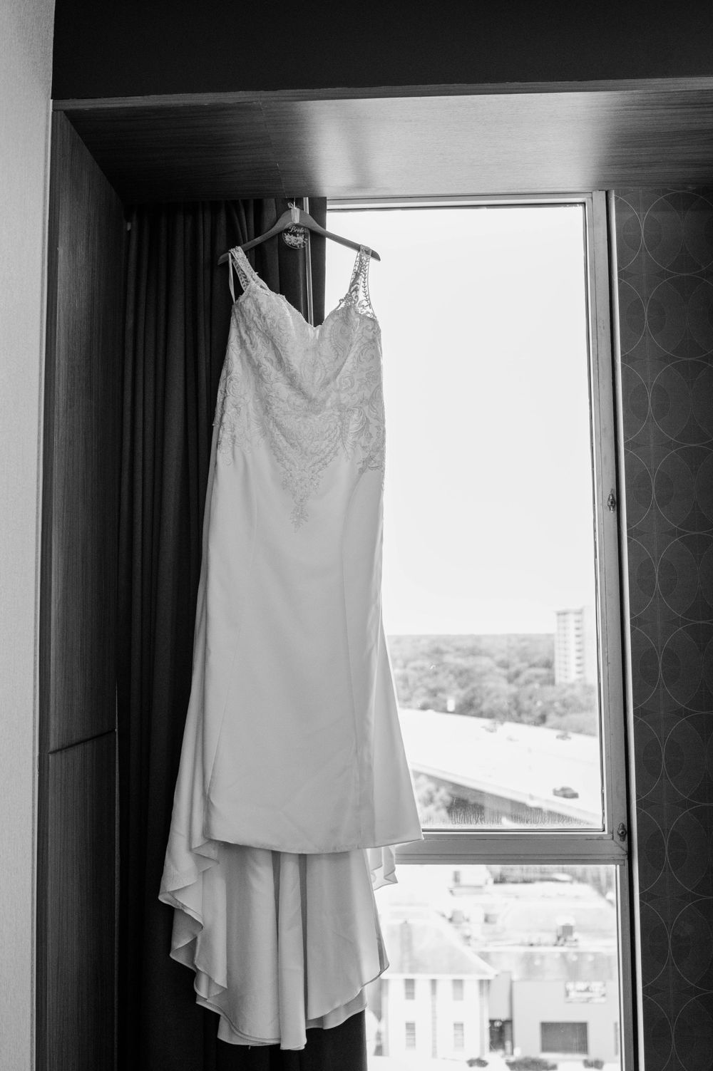 wedding dress hanging from window sill
