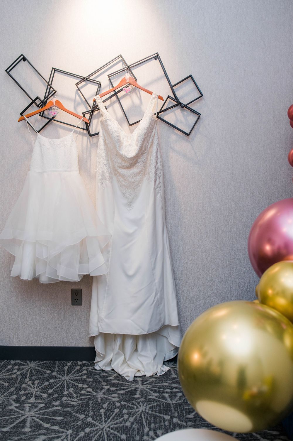 wedding dress hanging next to flower girl dress