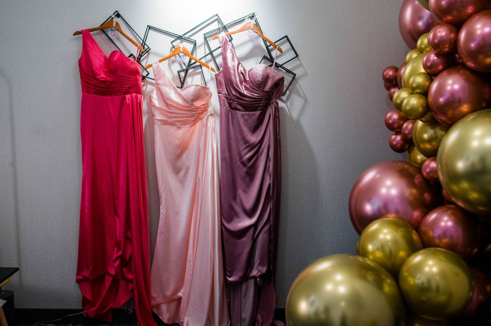 bridesmaid gowns hanging from wall