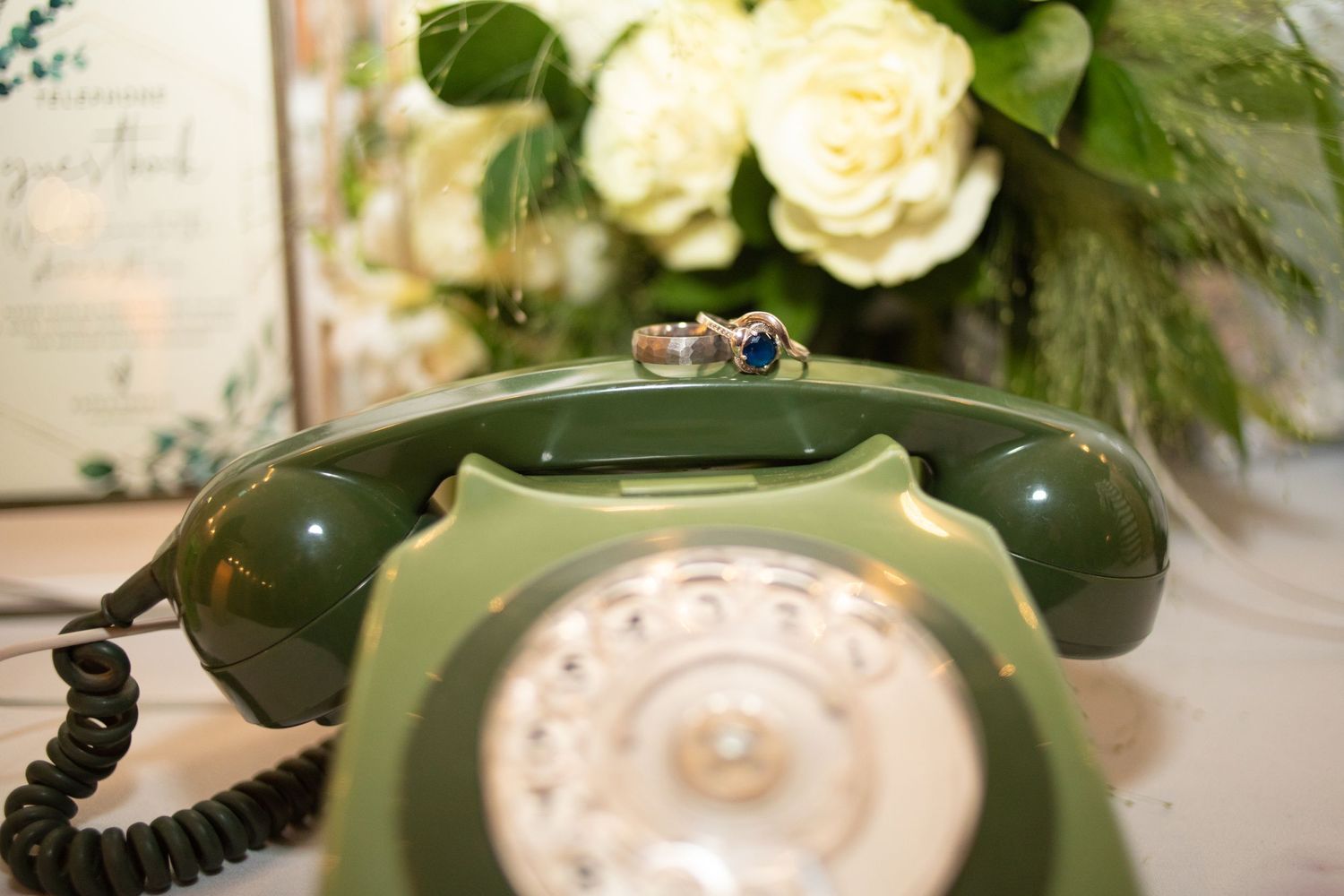Wedding rings on telephone recording set on couples wedding day