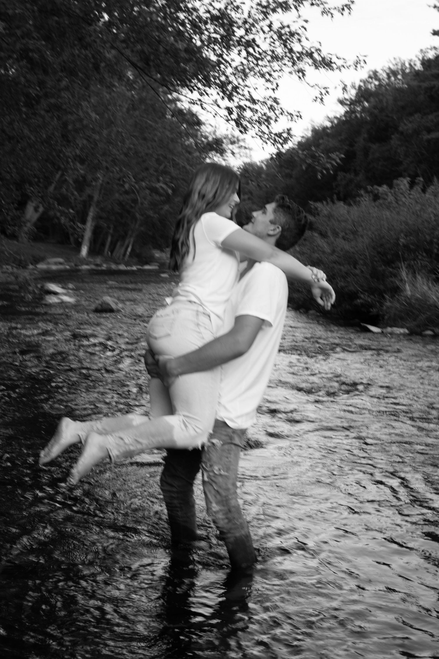 Black and white series showing romantic couple spinning and dancing in an outdoor setting.