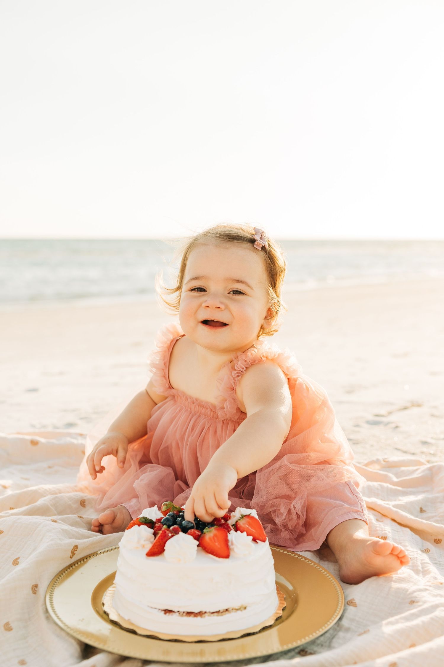 Baby girls first birthday smash cake photography on Siesta Key Beach at sunset by Sarasota Family Photography.