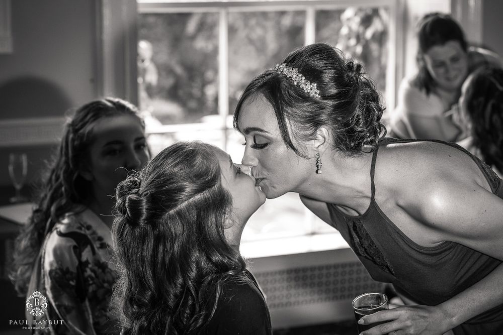 Intimate moment captured during preparation with dark formal attire.