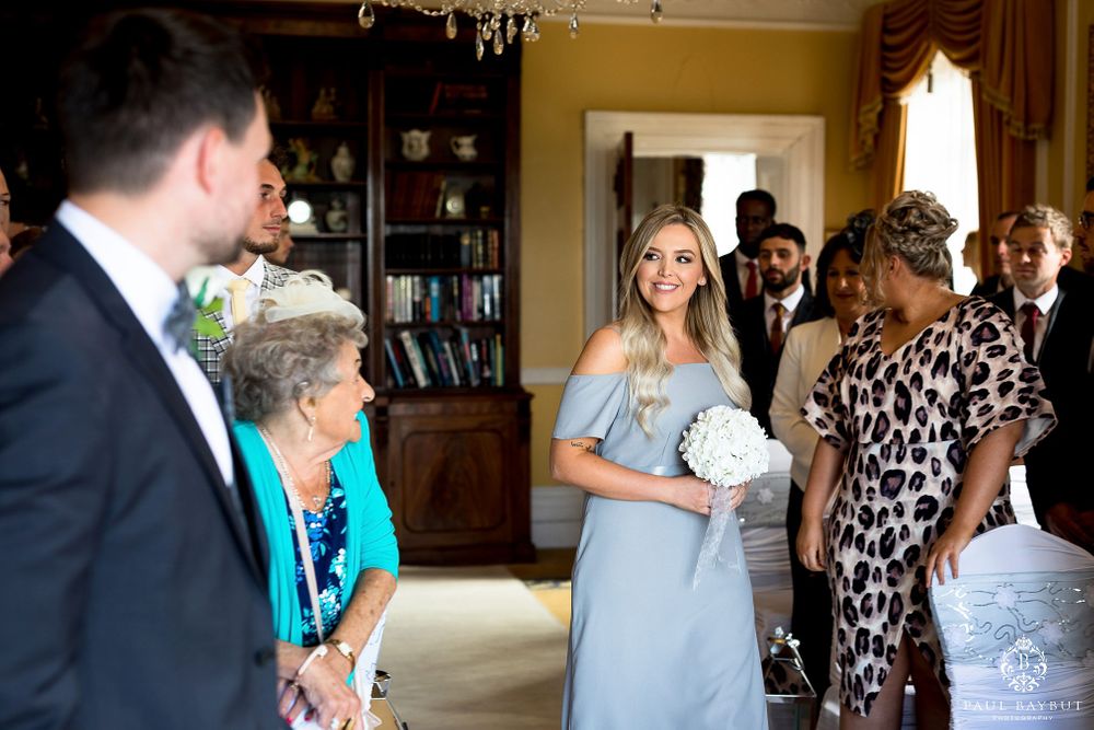 Wedding party members gather in formal attire during pre-ceremony celebrations.