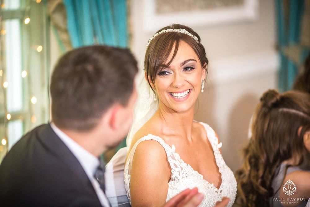 Joyful moment captured during wedding reception with bright natural lighting.
