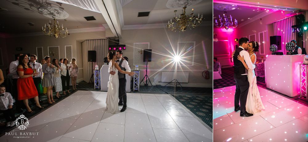 Wedding reception dance floor with white decor and pink lighting.