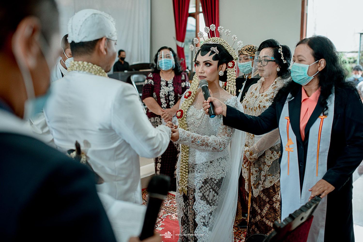 Wedding ceremony participants gathering during traditional Indonesian celebration.