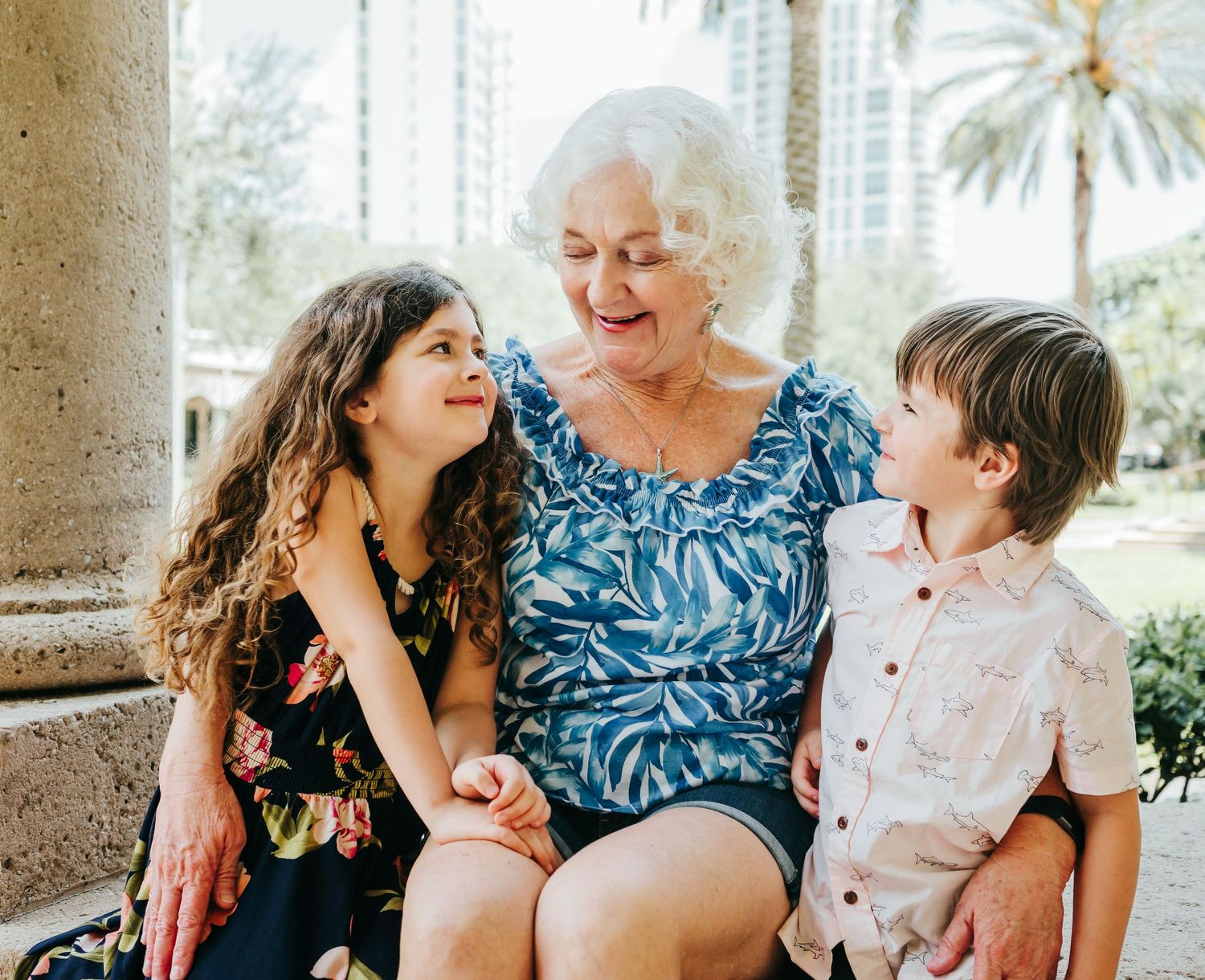 Outdoor Family Session in St. Pete, FL; Grandmother posing with grandkids near museum