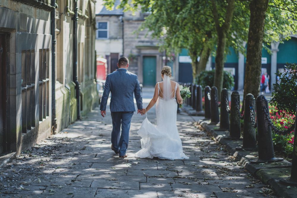 bride and groom walking hand in hand
