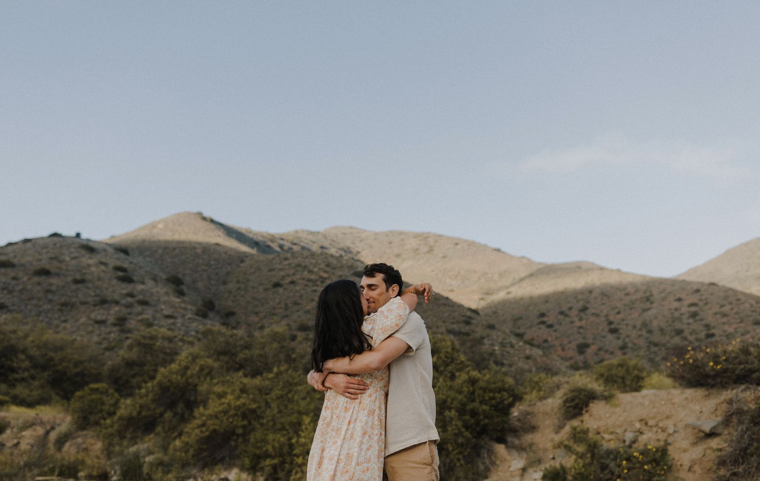 E. Noelle Photography couple engagement in the Los Angeles Malibu hills, kissing in front of mountain landscape