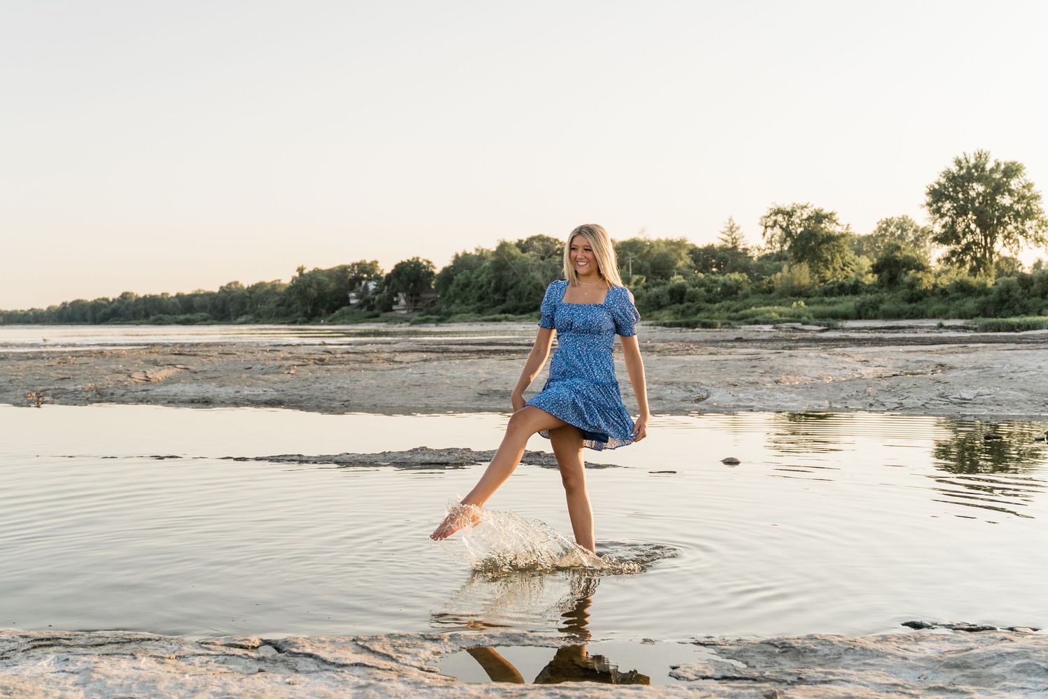 Toledo senior photographer session featuring Springfield senior in blue dress and hat at golden hour.