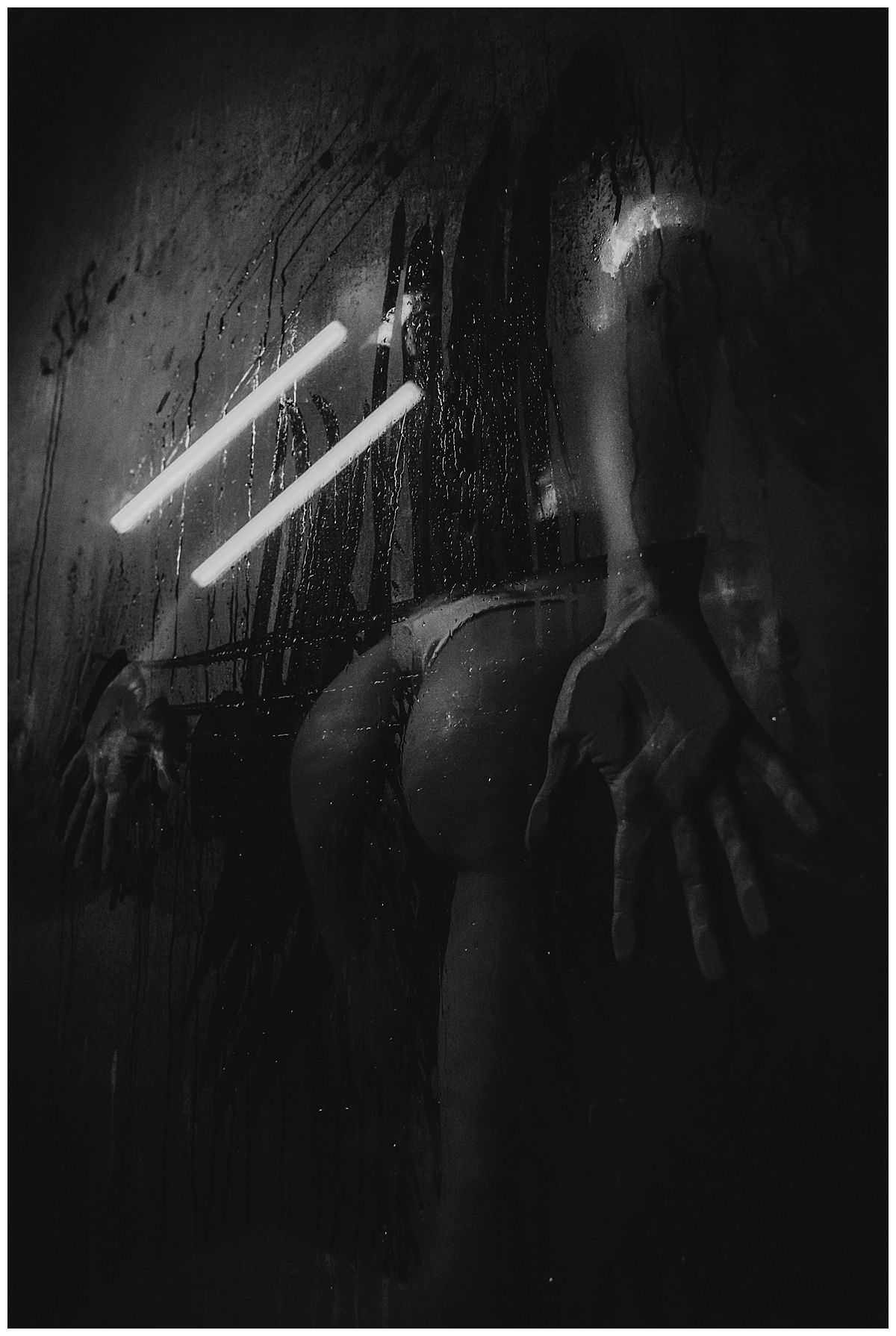 Dark atmospheric scene with bright light beams cutting through shadows.