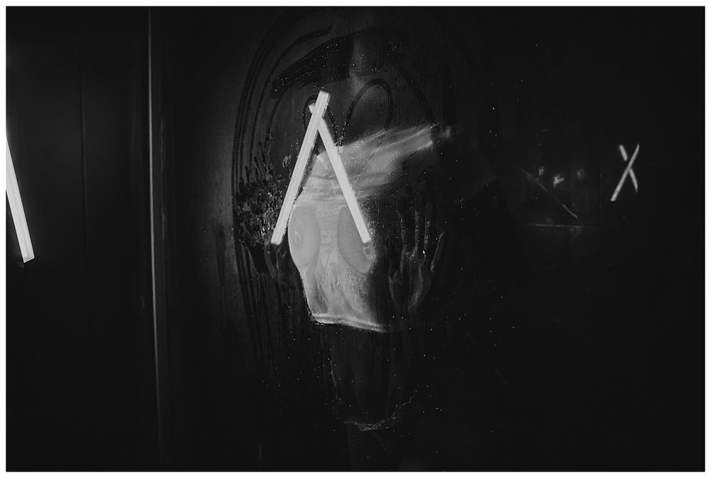 Abstract black and white composition with ghostly silhouettes and light trails.