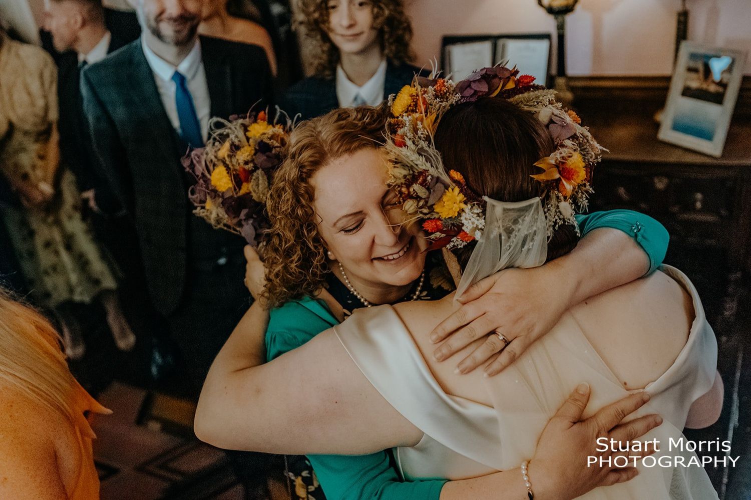 wedding guest hugs the bride after the ceremony at Ruthin castle wedding venue. Stuart Morris Photography.